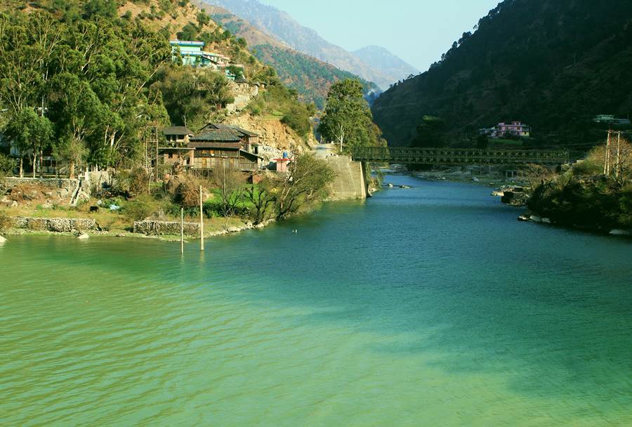The back water of the Larji Project extends up to Aut and beyond till the confluence of Sainj and Tirthan rivers at Larji village. The deference between the color of the two rivers is indicative of the absence/ presence of construction activities going on in the two valleys. While the clear turquoise blue waters of The Tirthan show that there is little siltation upstream, the turbid waters of the Sainj speaks about the volume of silt coming into the stream as a result of heavy construction for hydro power projects.                                                                                                                                         Pic Date : 25/02/2014